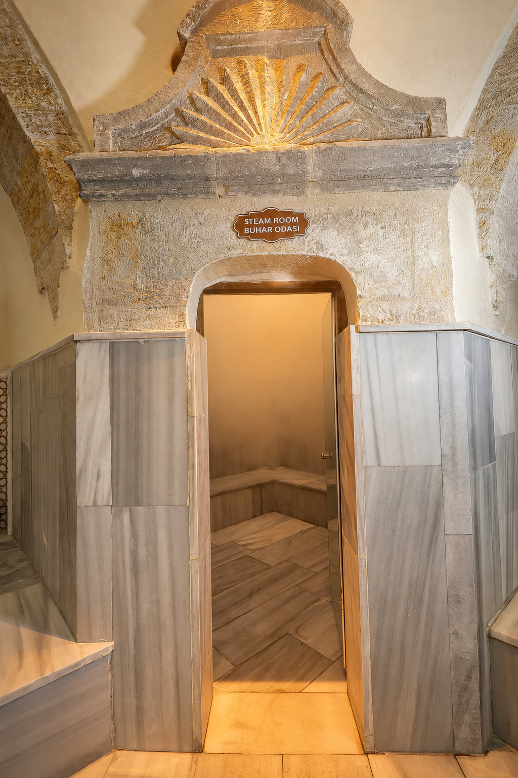 Warm doorway leading between the marble rooms inside Ürgüp Hamam.